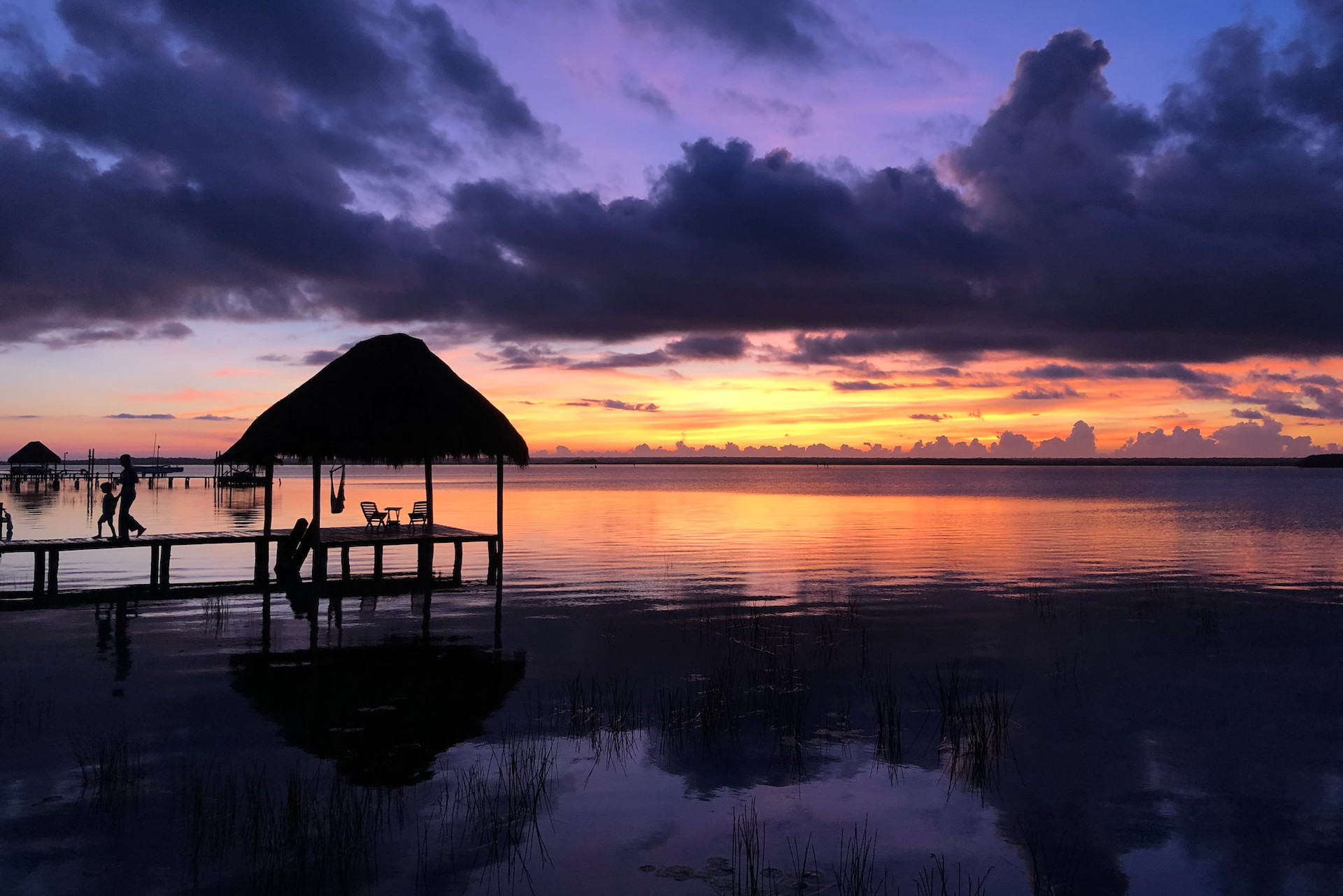 Purple sunset with water and seating area